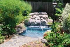 combination-pool-and-spa-with-waterfall-in-an-inviting-garden-setting