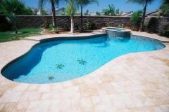 free-form-pool-with-paver-decking-raised-spa-with-spillover-and-tile-mosaic