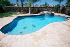 free-form-pool-with-paver-decking-raised-spa-with-spillover-and-tile-mosaic_0-min
